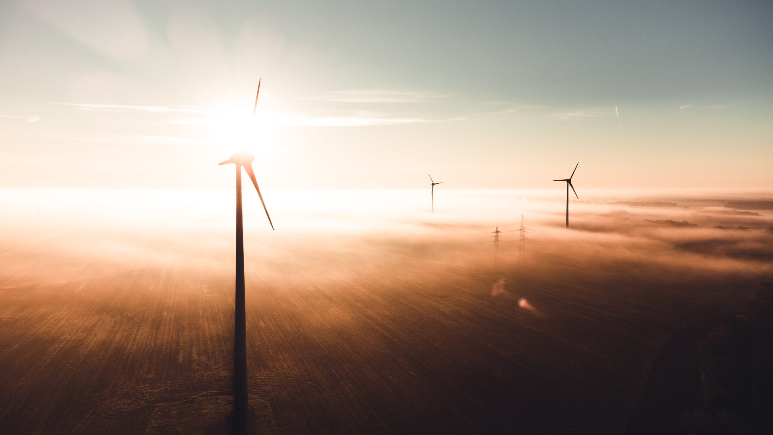 Renewable energy wind turbines in the background of a sunset